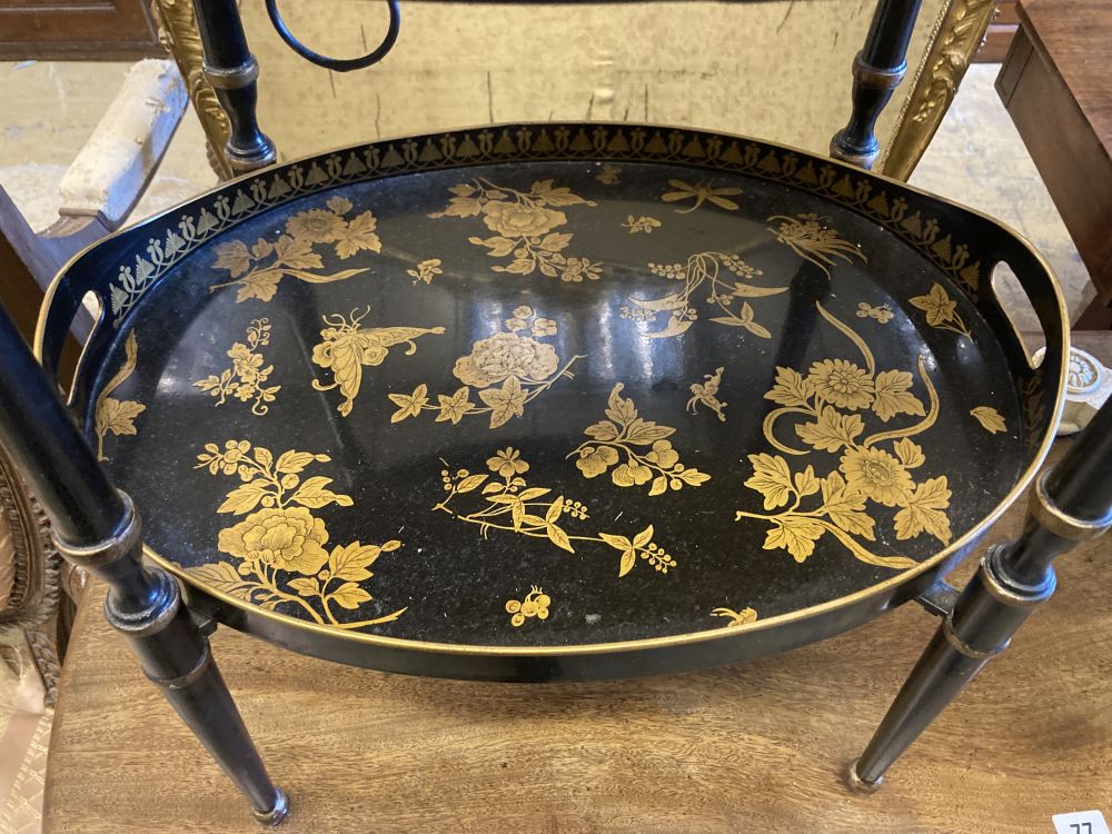 A black and gold japanned two tier toleware tray table, width 48cm, depth 36cm, height 57cm
